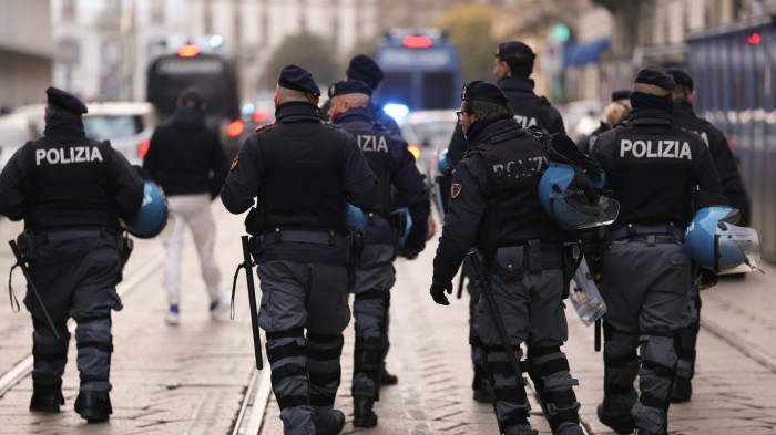 Security officers detain a suspect while fans watch at Winter Olympics arena