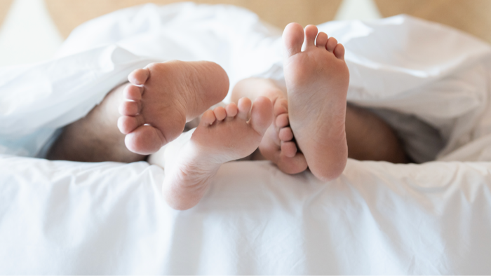 Couple embracing in reverse cowgirl sex position during intimate moment