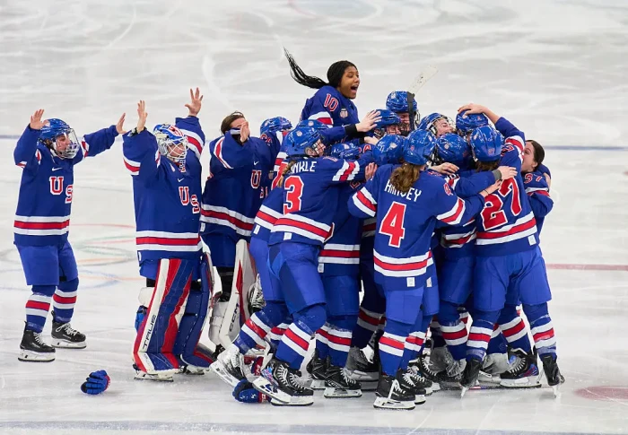 Women’s hockey team members regroup after Olympics, holding prideful expressions amid declined invitation.