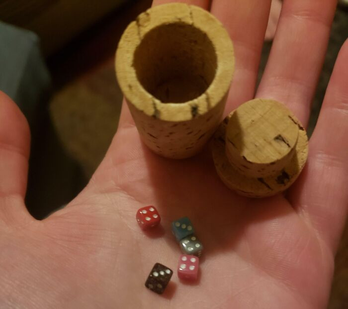 7. They ordered wine online, and it came with a small set of dice enclosed within a hollow cork.