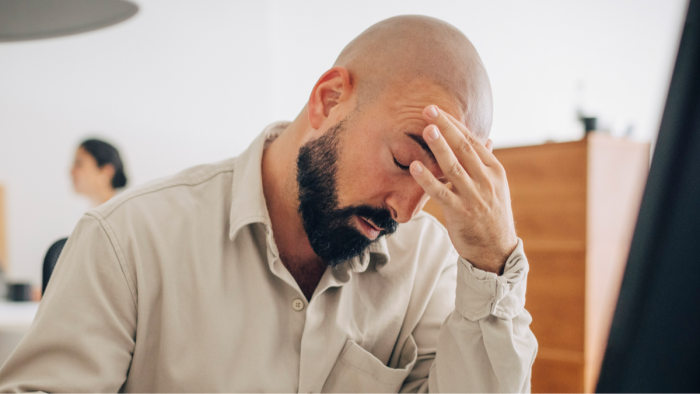 Tired person resting on couch, representing exhaustion and energy decline in forties