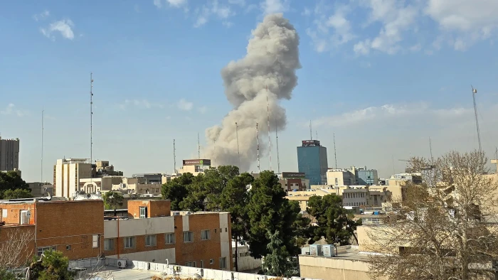 Airport tarmac with commercial aircraft, U.S. travel warning amid regional conflict