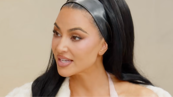 Kim Kardashian appears on a podcast microphone, discussing Sussexes photo removal