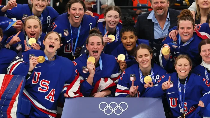 US women’s hockey athletes celebrate achievements, advocating equality in sports leadership roles.