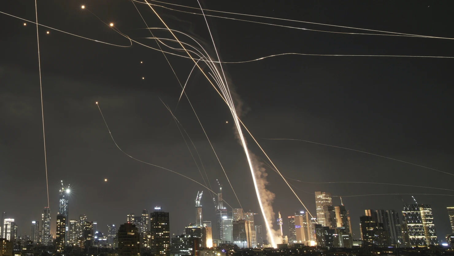A projectile hit buildings as Israel’s Iron Dome intercepted missiles over Tel Aviv on June 13, 2025.