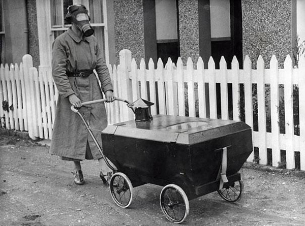 A Woman Taking Her Baby for a Stroll in a Gas-Resistant Baby Carriage.