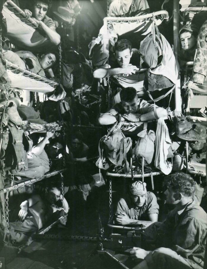 "Marines of the Fifth Marine Division, En Route to the Enemy's 'Gibraltar' of the Volcano Islands, Iwo Jima, Make Themselves as Comfortable as Possible in Their Cramped Quarters Aboard the Transport. February 1945. (Original Wartime Caption)"