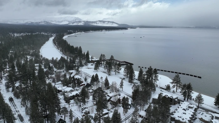 Families and children attend a memorial gathering, surrounded by snowy backcountry setting