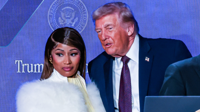 Nicki Minaj beside Donald Trump, hand-holding moment with tense body language