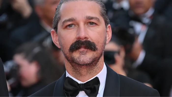 Shia LaBeouf holding a sign reading “Free Me” amid public concern