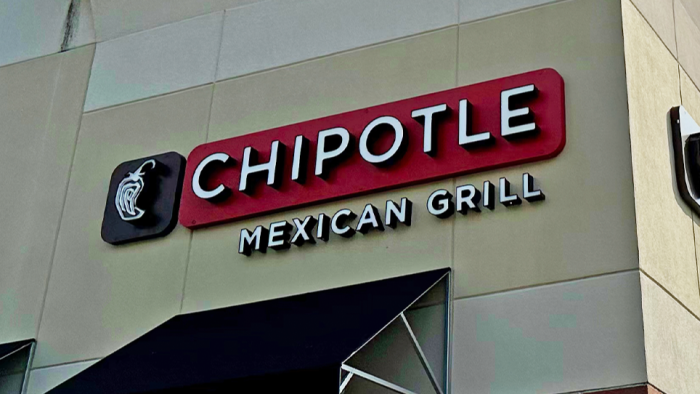 Smartphone showing Chipotle Instagram Reels promo, encouraging free entrée participation.