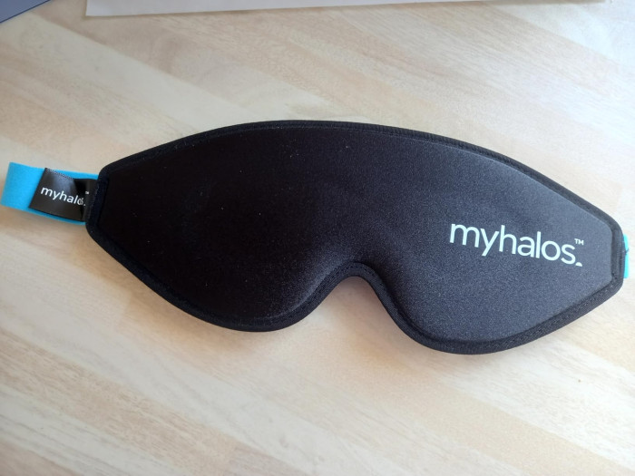 Blackout sleep mask covering eyes, promoting improved sleep quality and rest