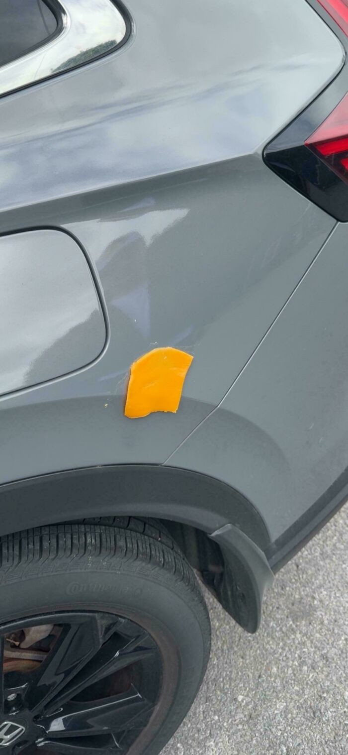 "Someone threw a cheese slice on the side of my car overnight. I stayed over at my friend's house and parked my car out front on the street. I woke up and found this one cheese slice on the side of my car. It was annoying to get off; what a mischievous prank."