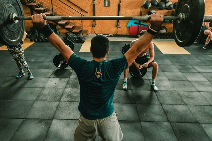 22. I saw a man lifting weights in the gym