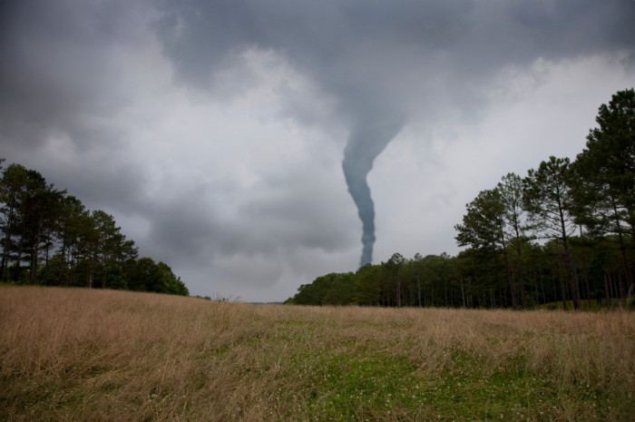 7. Man encounters a tornado behind him.