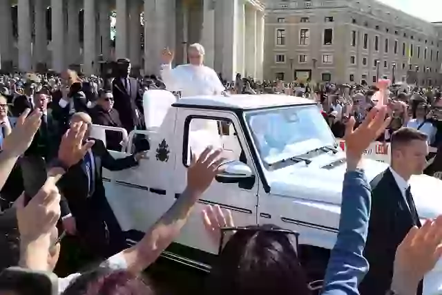 Riding in the open-top popemobile, Pope Leo arrived at St. Peter's Square in Vatican City.