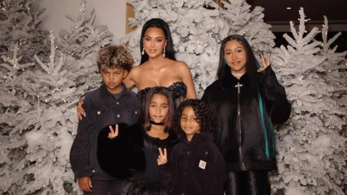 PETA protest sign criticizing Kim Kardashian’s Christmas puppy gifts and animal neglect